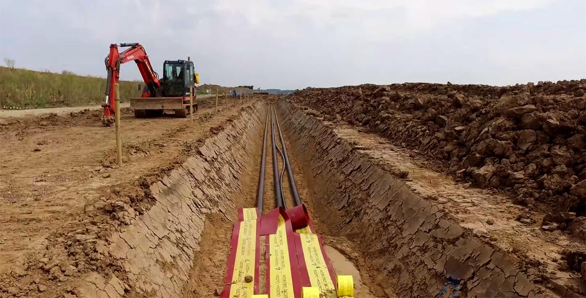 Open trench cable laying